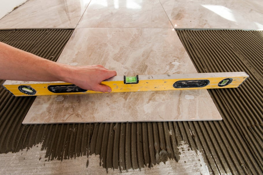 Ceramic tiles and tools for tiler. Floor tiles installation.